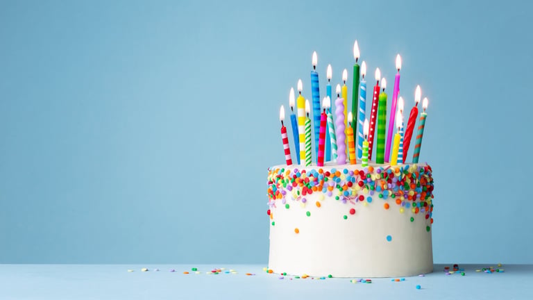 Celebration birthday cake with colorful sprinkles and twenty one colorful birthday candles