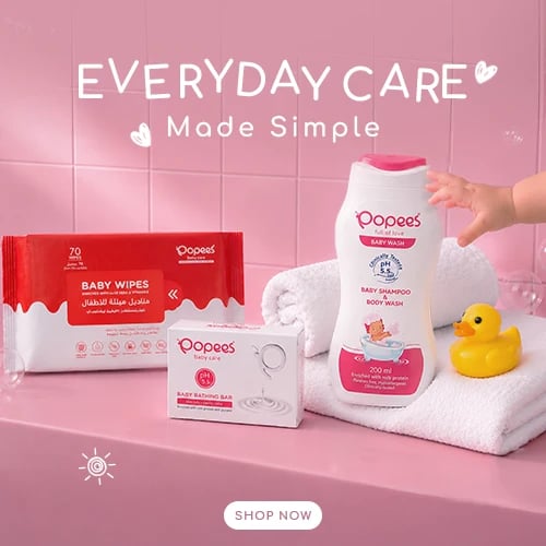 Pooees baby care products displayed on pink background with wipes, shampoo, towel, and rubber duck, Shop Now button